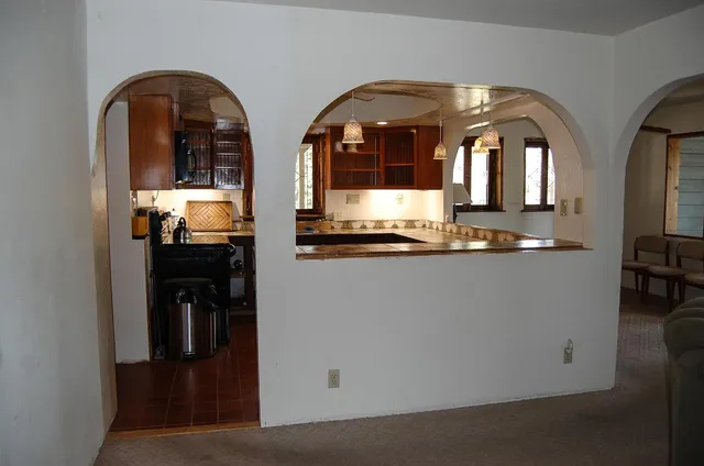 a kitchen with a sink appliances and cabinets