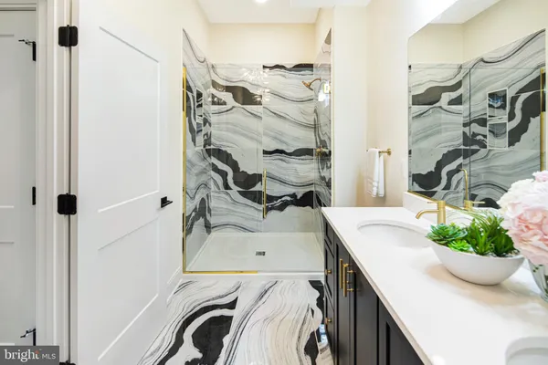 a bathroom with a sink a toilet and mirror