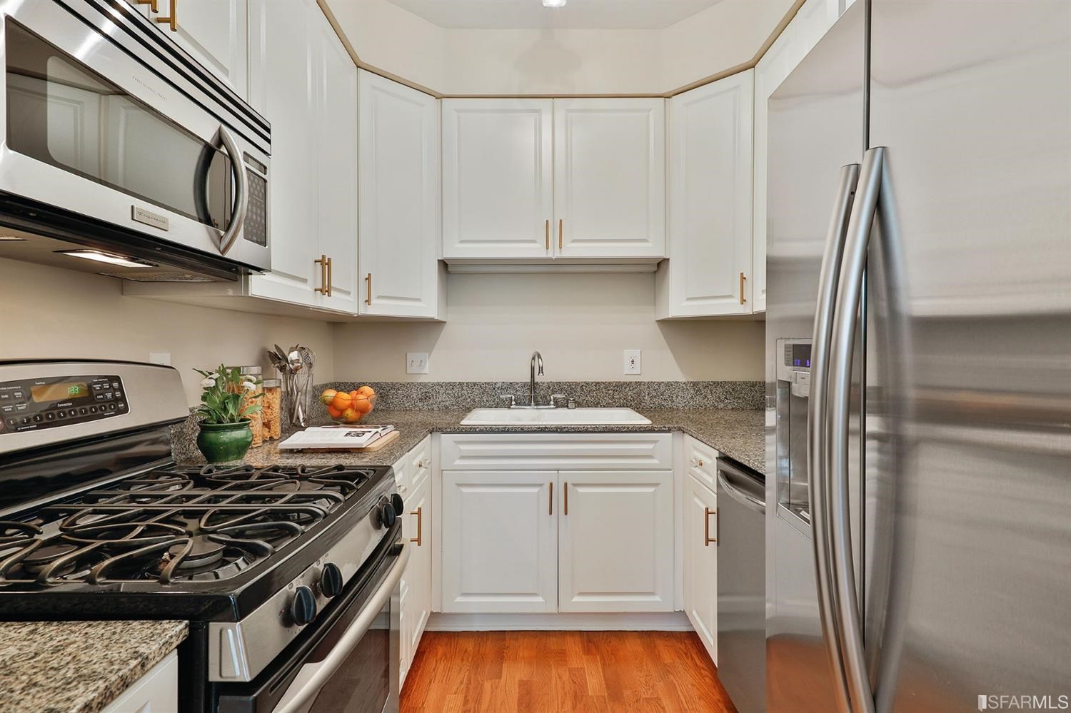 261 Henry Street, Unit A San Francisco, CA 94117 - Photo 14 of 64 a kitchen with stainless steel appliances granite countertop a stove and a refrigerator