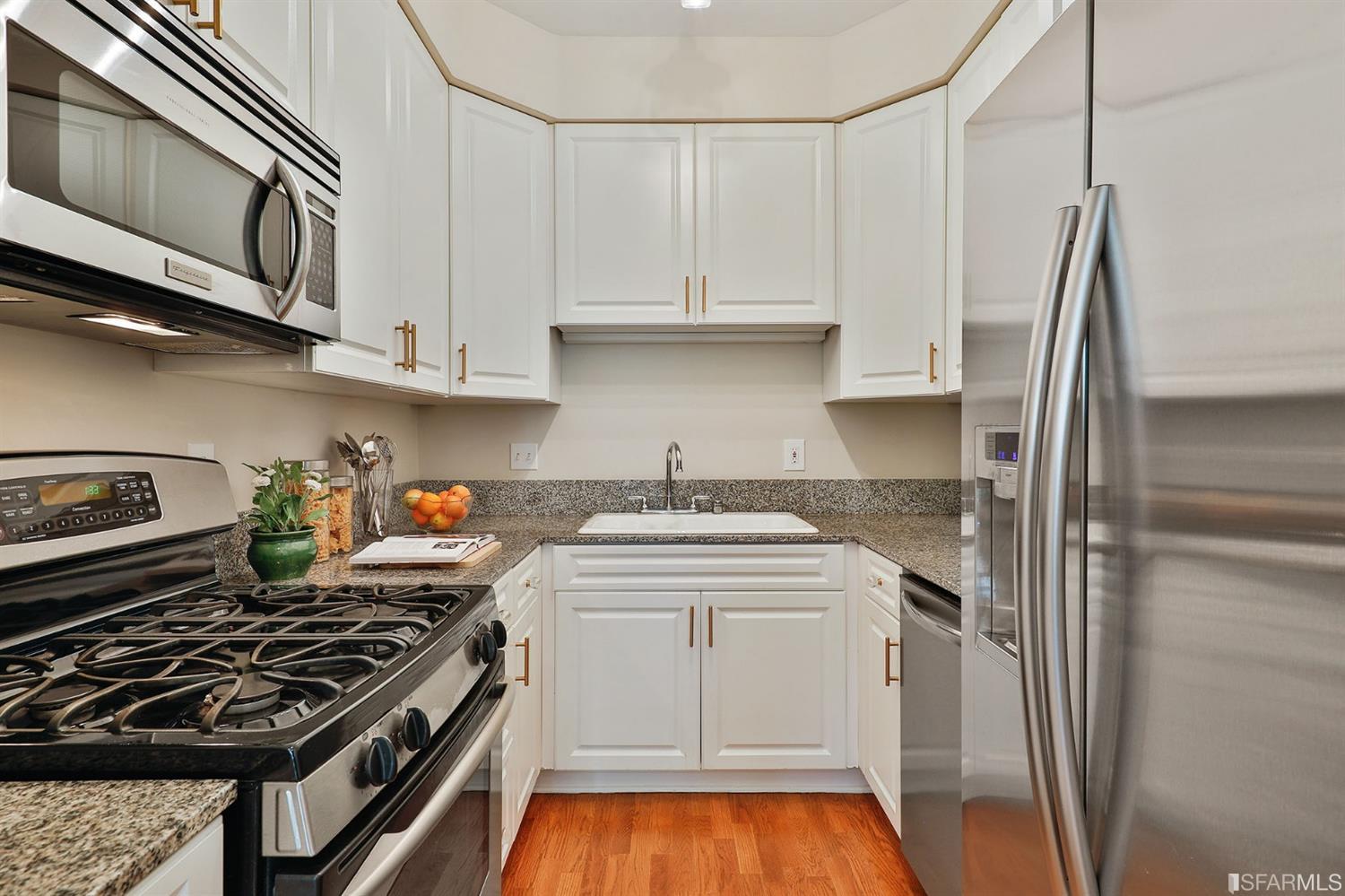 261 Henry Street, Unit A San Francisco, CA 94117 - Photo 46 of 64 a kitchen with stainless steel appliances granite countertop a stove and a refrigerator