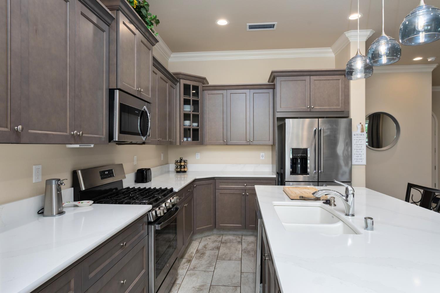 2227 North Highland Avenue Clovis, CA 93619 - Photo 13 of 48 a kitchen with kitchen island a sink appliances and cabinets