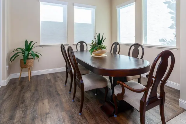 a view of a dining room with furniture and wooden floor