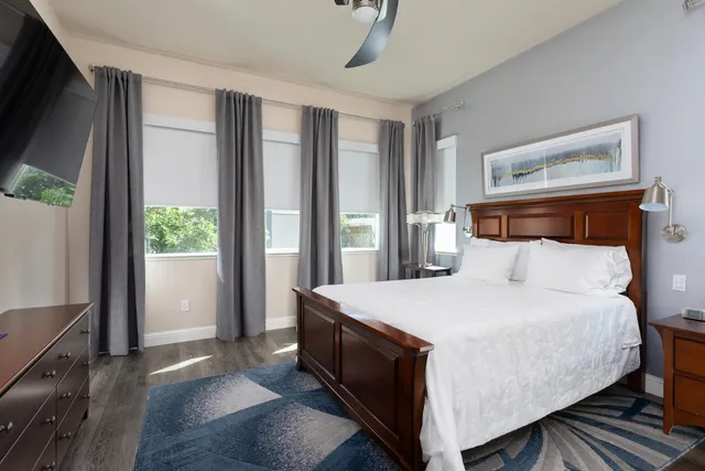 a bed sitting in a bedroom next to a window