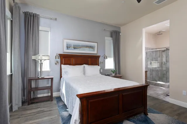 a bedroom with a bed and a flat screen tv