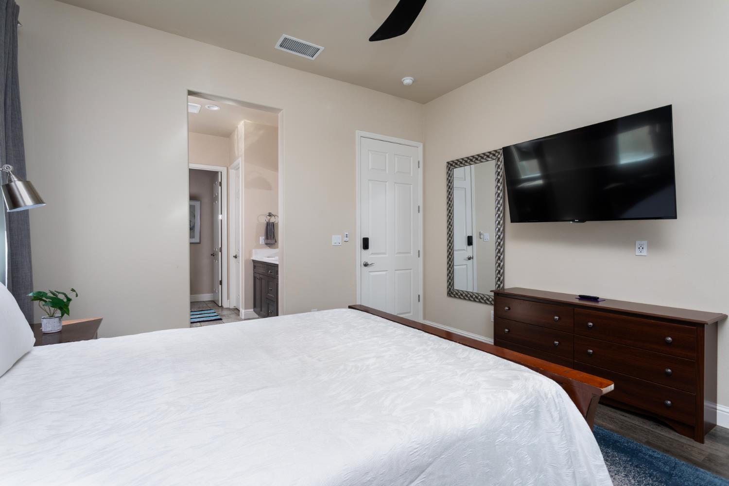 2227 North Highland Avenue Clovis, CA 93619 - Photo 18 of 48 a bedroom with a bed and a flat screen tv