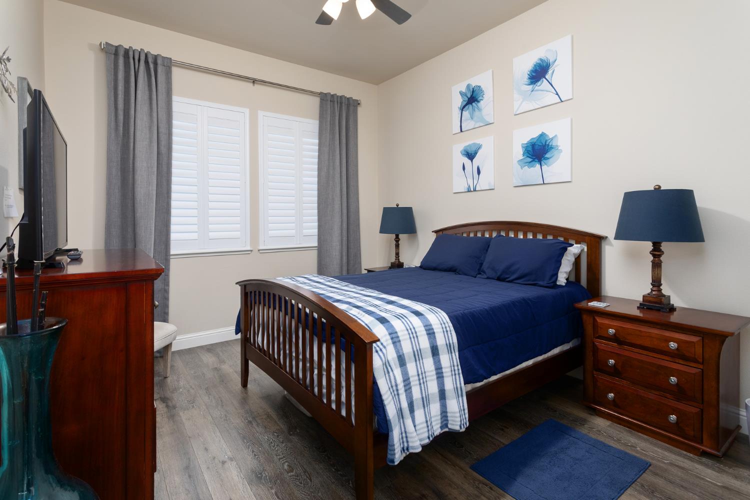 2227 North Highland Avenue Clovis, CA 93619 - Photo 22 of 48 a bedroom with a bed and a flat tv screen on a dresser