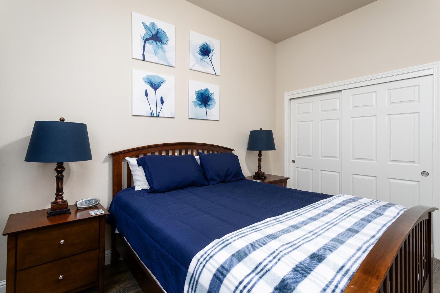 2227 North Highland Avenue Clovis, CA 93619 - Photo 23 of 48 a bedroom with a bed and a lamp on dresser