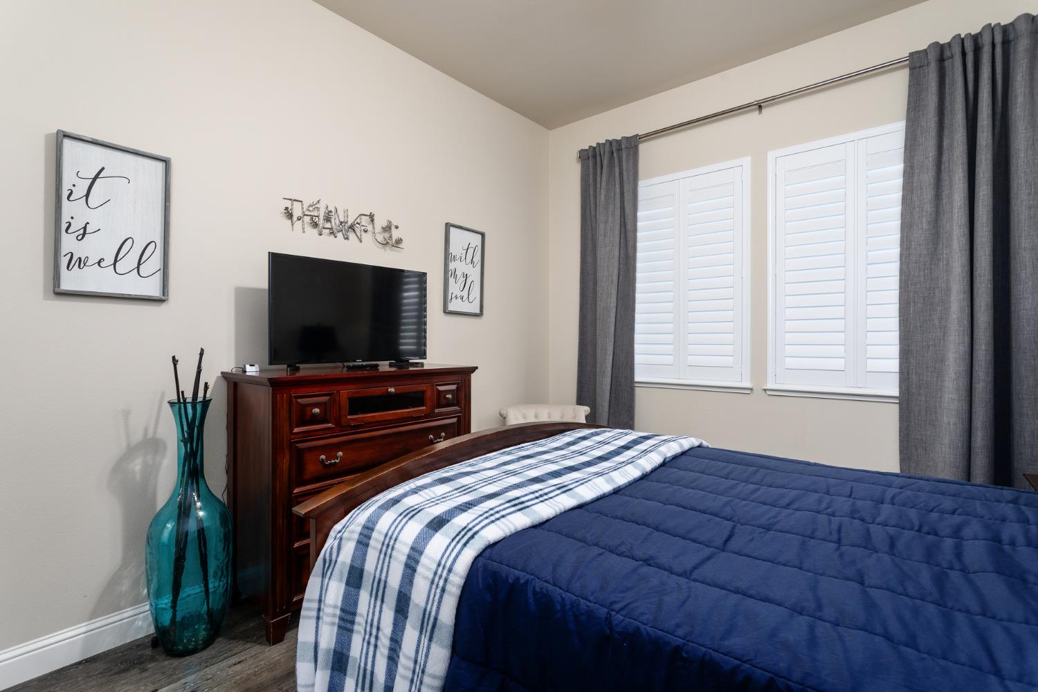2227 North Highland Avenue Clovis, CA 93619 - Photo 24 of 48 a bedroom with a bed and a flat screen tv