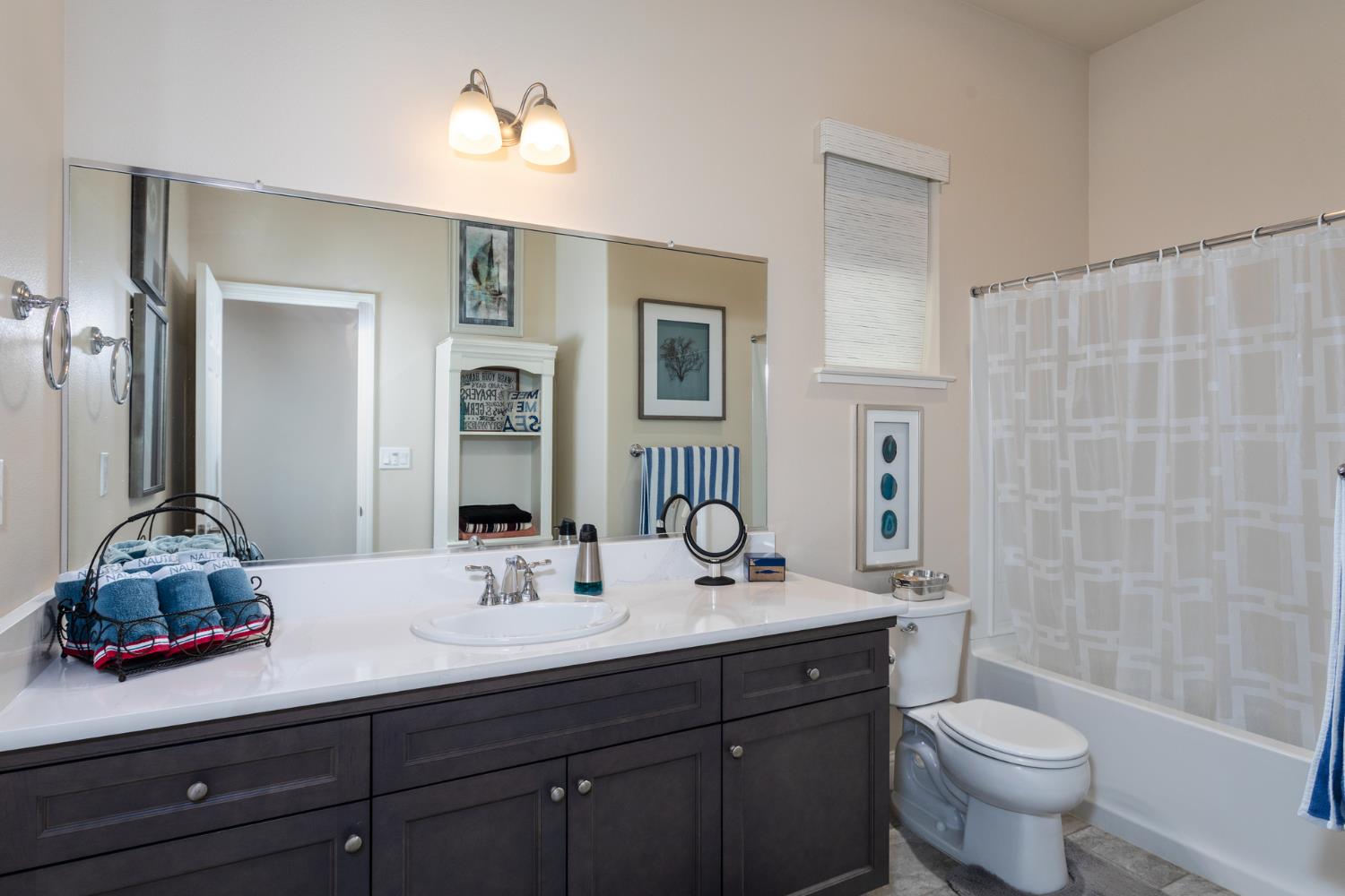 2227 North Highland Avenue Clovis, CA 93619 - Photo 25 of 48 a bathroom with a double vanity sink toilet and a mirror