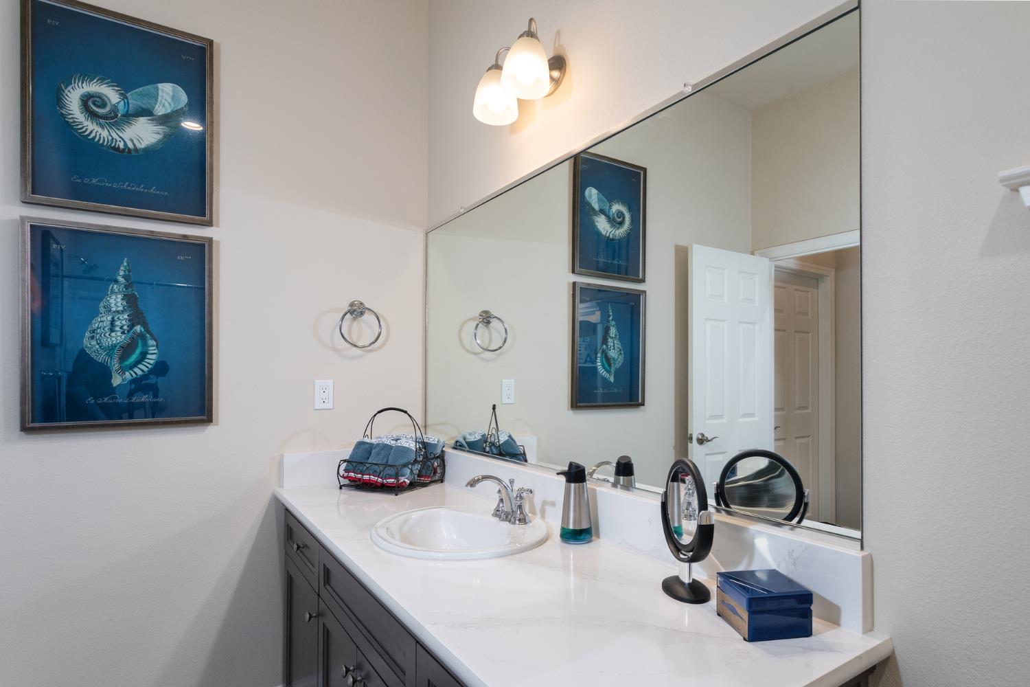 2227 North Highland Avenue Clovis, CA 93619 - Photo 27 of 48 a bathroom with a sink and a mirror