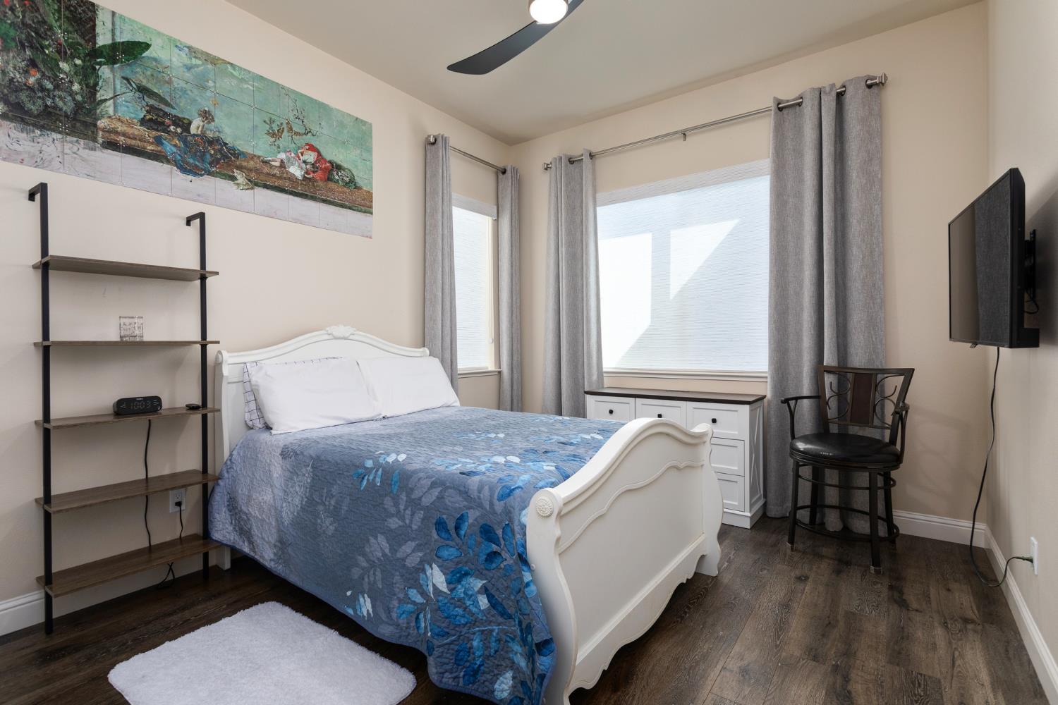 2227 North Highland Avenue Clovis, CA 93619 - Photo 28 of 48 a bedroom with a bed and a flat screen tv