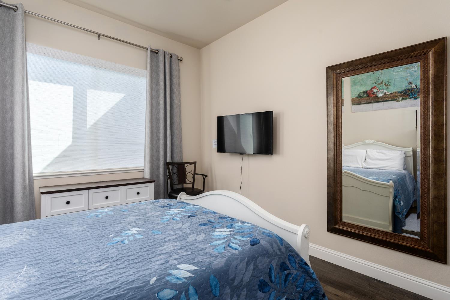 2227 North Highland Avenue Clovis, CA 93619 - Photo 30 of 48 a bedroom with a bed and a flat tv screen on dresser