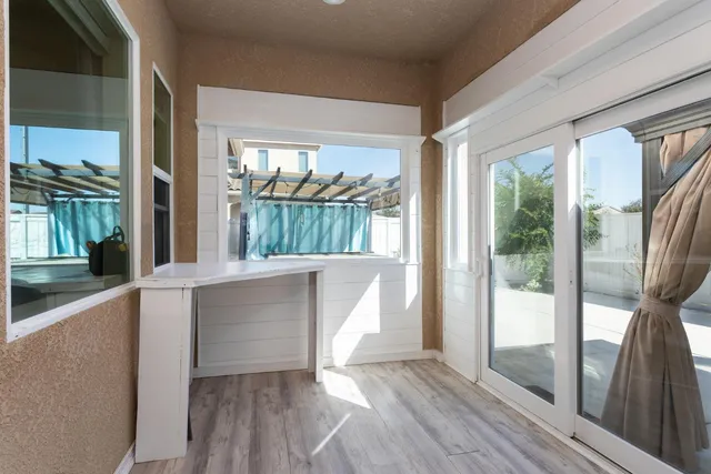 hallway with wooden floor and glass door