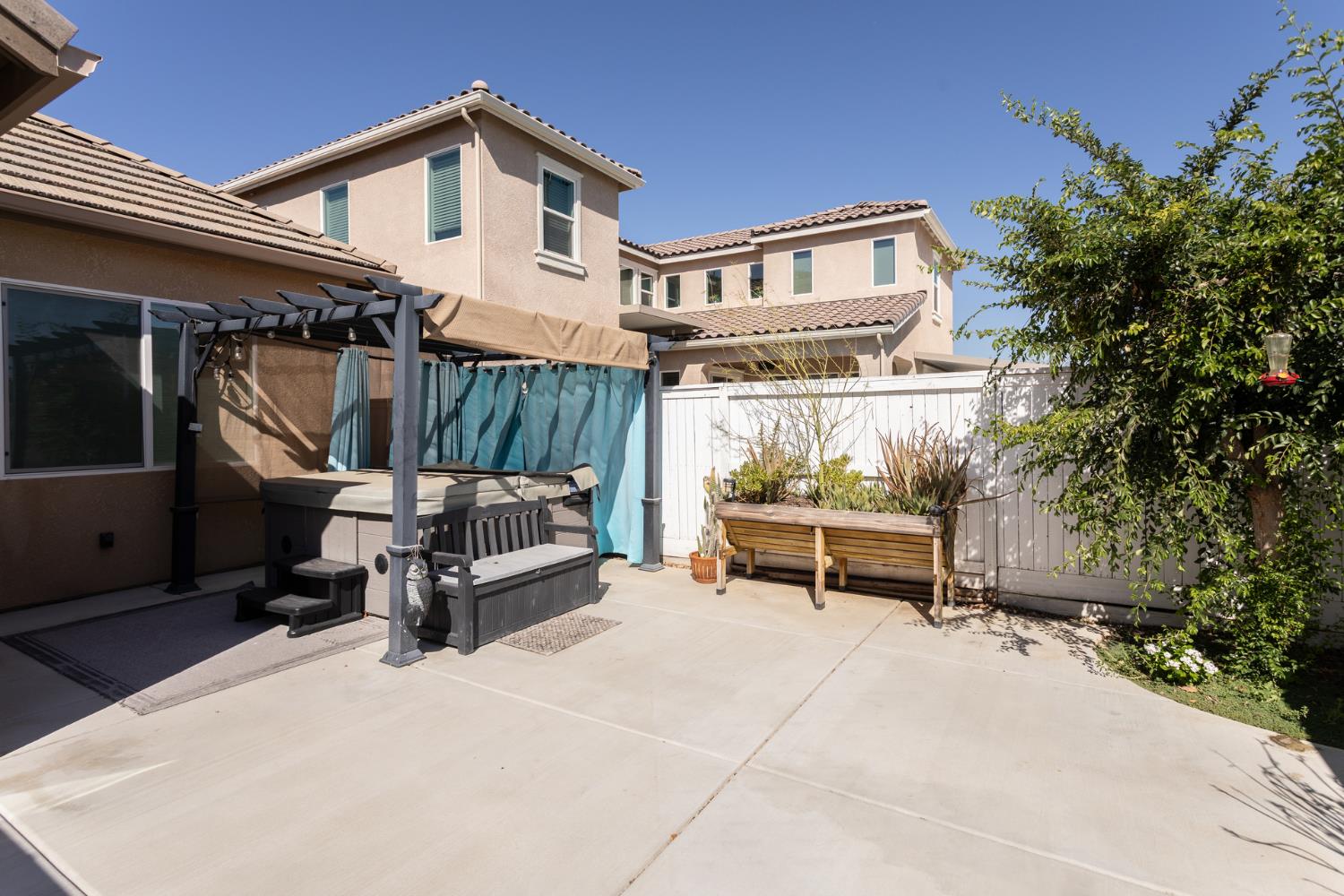 2227 North Highland Avenue Clovis, CA 93619 - Photo 36 of 48 a view of a roof deck with table and chairs with wooden floor and fence