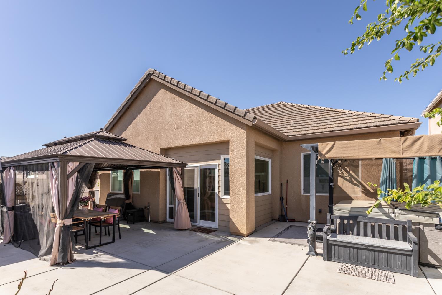2227 North Highland Avenue Clovis, CA 93619 - Photo 46 of 48 a patio with a table and chairs under an umbrella