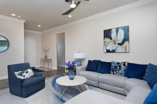 a living room with furniture and a potted plant