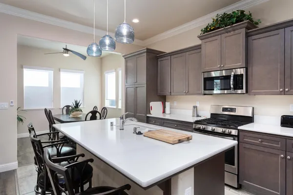 a kitchen with stainless steel appliances a stove a microwave and cabinets