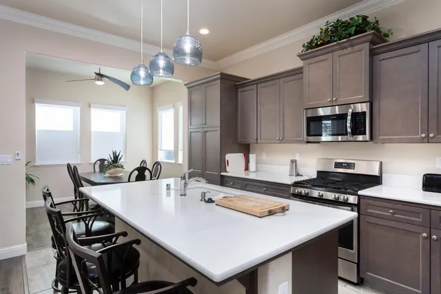 a kitchen with stainless steel appliances a stove a microwave and cabinets