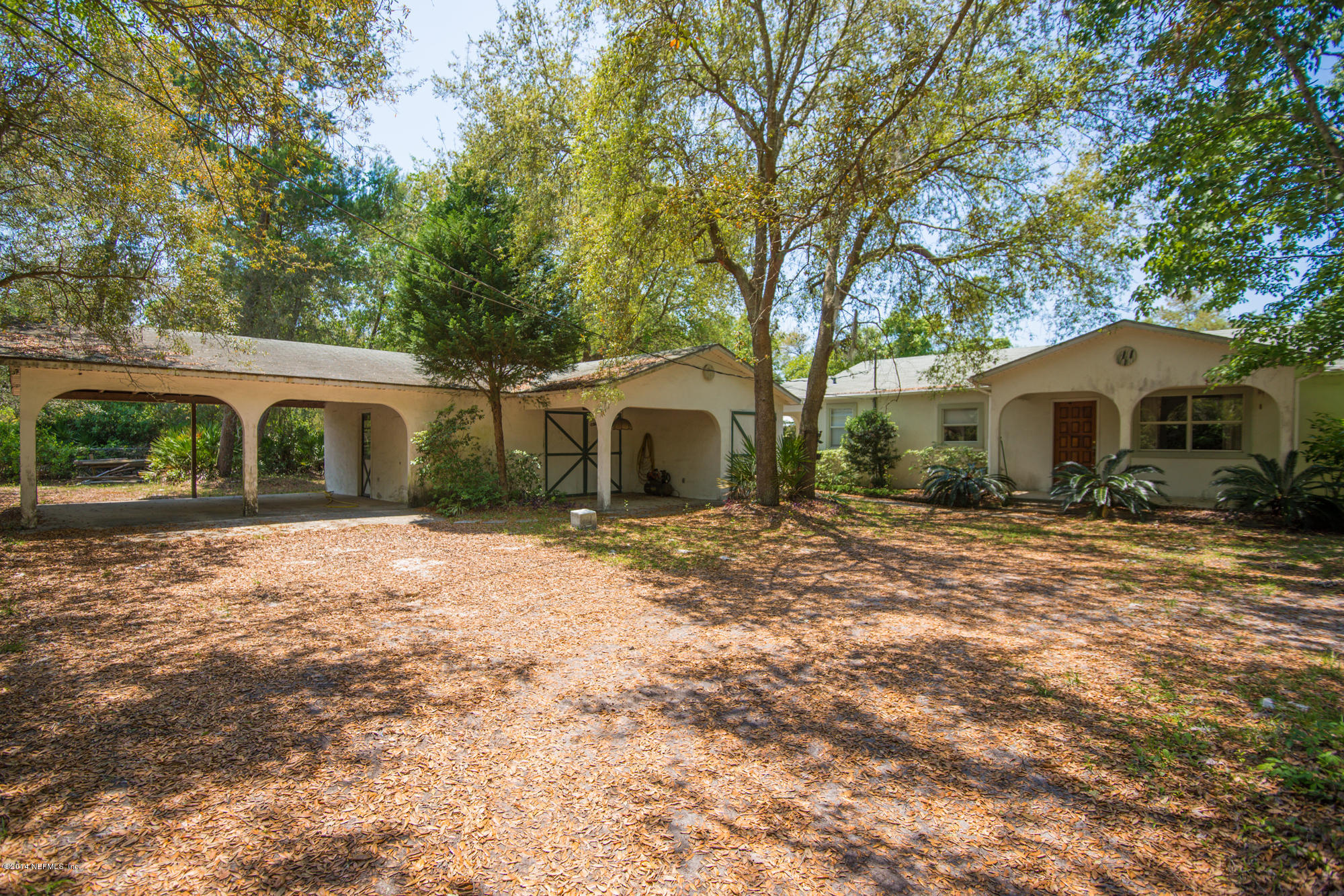 865 Kings Estate Road St. Augustine, FL 32086 - Photo 2 of 24 a front view of a house with a garden and porch