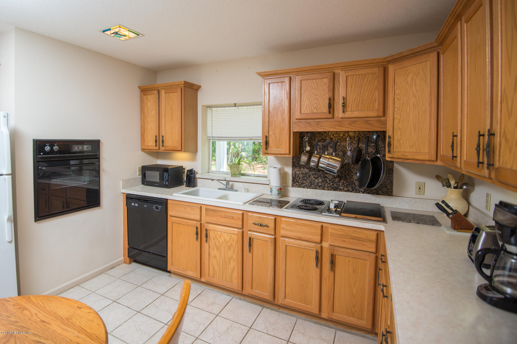 865 Kings Estate Road St. Augustine, FL 32086 - Photo 8 of 24 a kitchen with granite countertop a sink a stove and cabinets