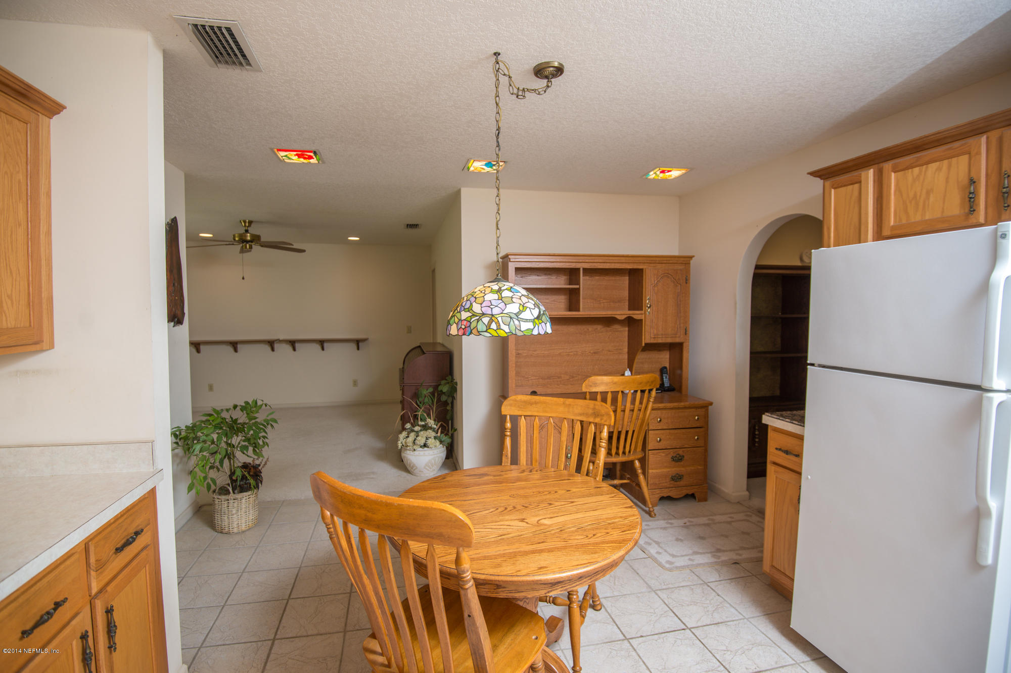 865 Kings Estate Road St. Augustine, FL 32086 - Photo 9 of 24 a kitchen with stainless steel appliances kitchen island granite countertop dining table chairs and a refrigerator