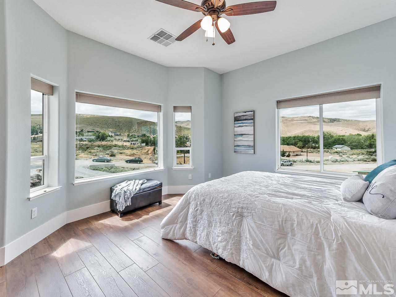 300 Andrew Lane Reno, NV 89521 - Photo 14 of 25 a bedroom with a large bed and a large window