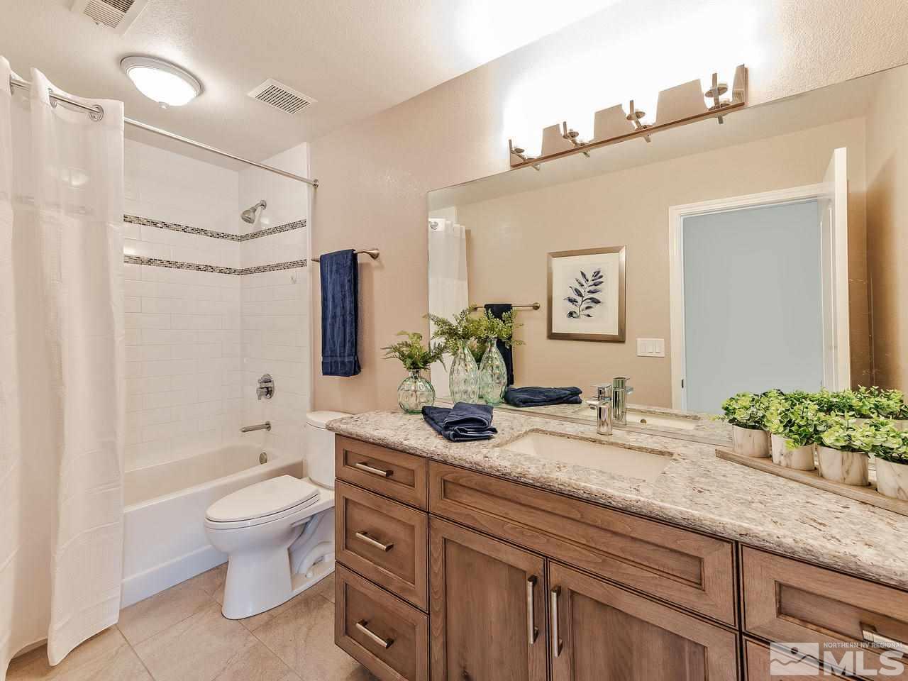 300 Andrew Lane Reno, NV 89521 - Photo 15 of 25 a bathroom with a granite countertop sink a toilet and shower
