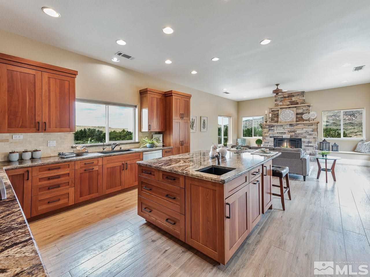 300 Andrew Lane Reno, NV 89521 - Photo 6 of 25 a kitchen with stainless steel appliances granite countertop a stove a sink dishwasher a refrigerator and a dining table with wooden floor