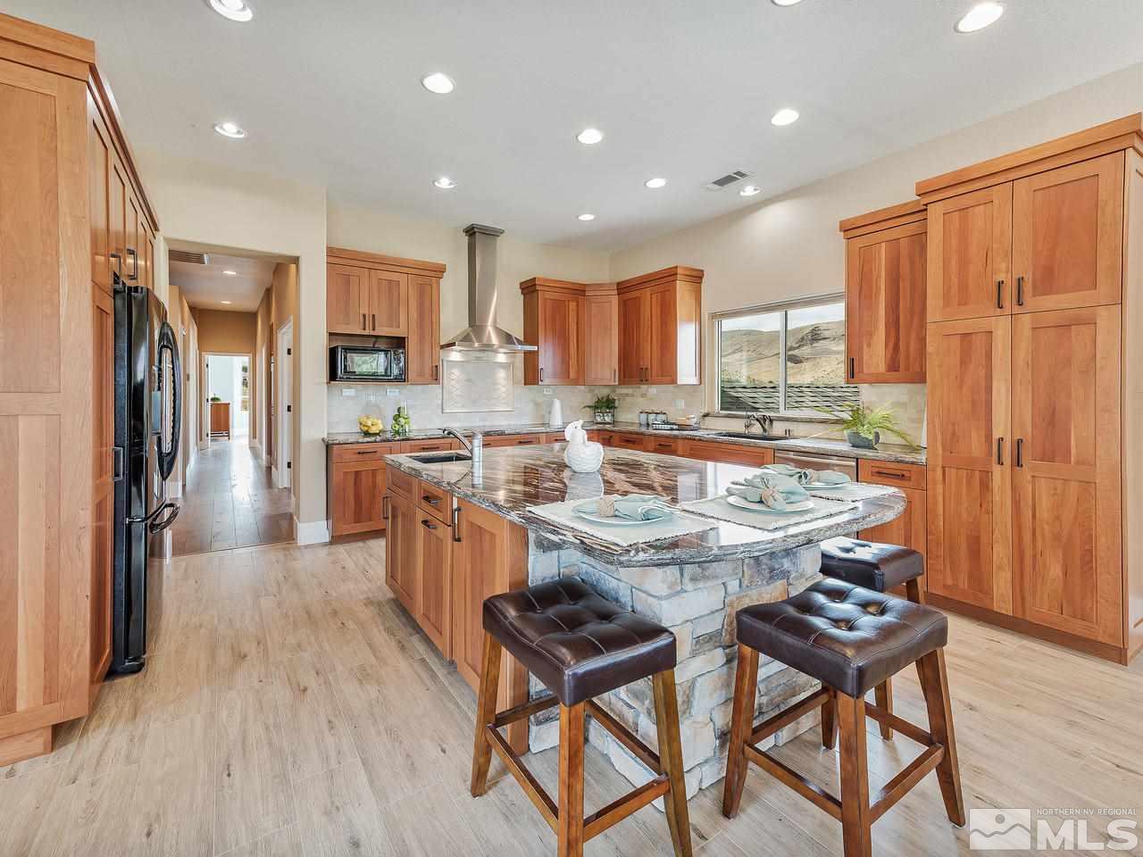 300 Andrew Lane Reno, NV 89521 - Photo 7 of 25 a kitchen with stainless steel appliances granite countertop table chairs and a refrigerator