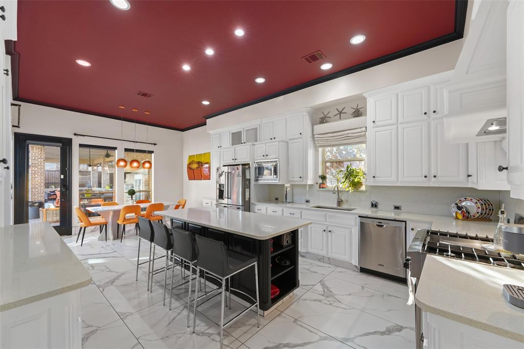 3310 Collard Road Arlington, TX 76017 - Photo 11 of 40 a kitchen with stainless steel appliances kitchen island granite countertop a stove sink and cabinets