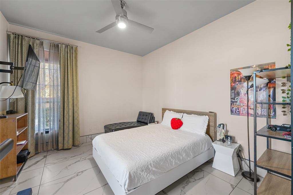 3310 Collard Road Arlington, TX 76017 - Photo 19 of 40 a bed room with a bed and a walk in closet