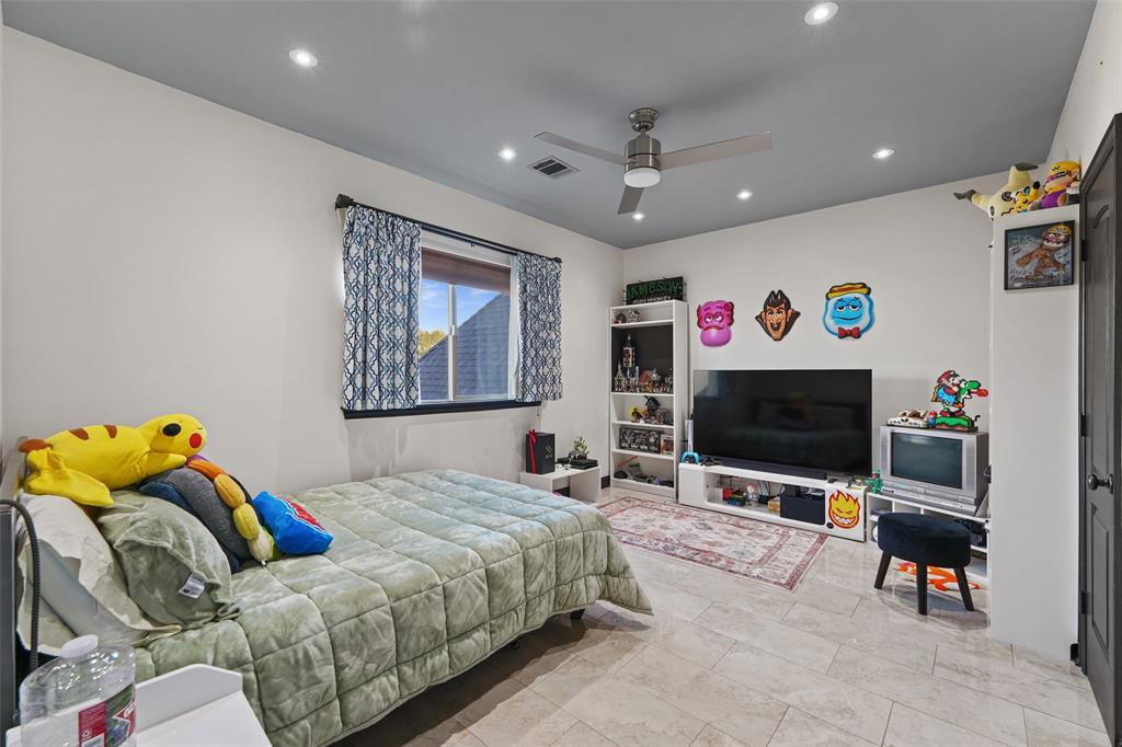 3310 Collard Road Arlington, TX 76017 - Photo 24 of 40 a bedroom with a bed and a flat screen tv