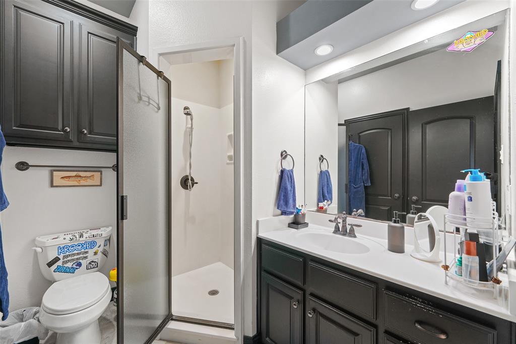 3310 Collard Road Arlington, TX 76017 - Photo 25 of 40 a bathroom with a granite countertop sink toilet and shower