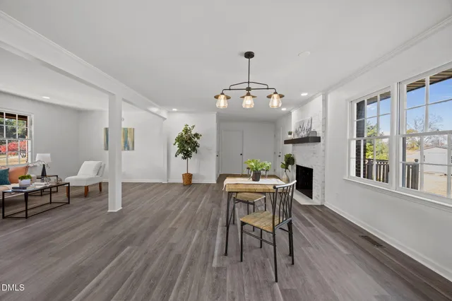 a view of a dining room with furniture window and wooden floor