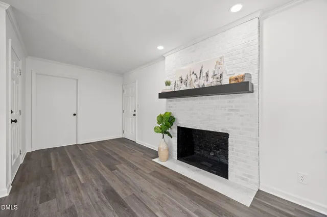 a view of an empty room with a fireplace