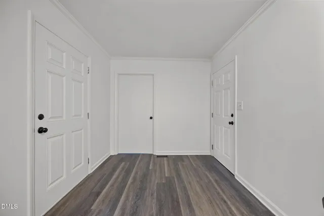a view of a room with wooden floor