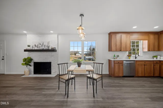 a kitchen with a table chairs sink and cabinets