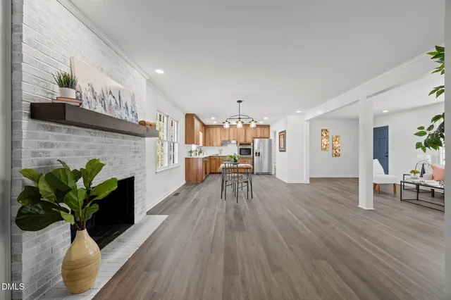 a living room with furniture dining room and a fireplace