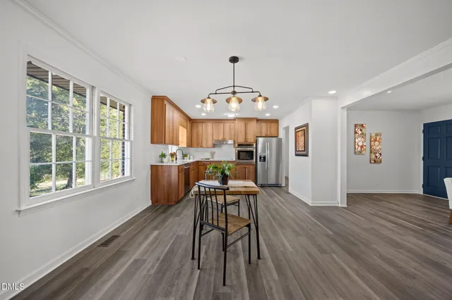 a view of a dining room with furniture window and wooden floor