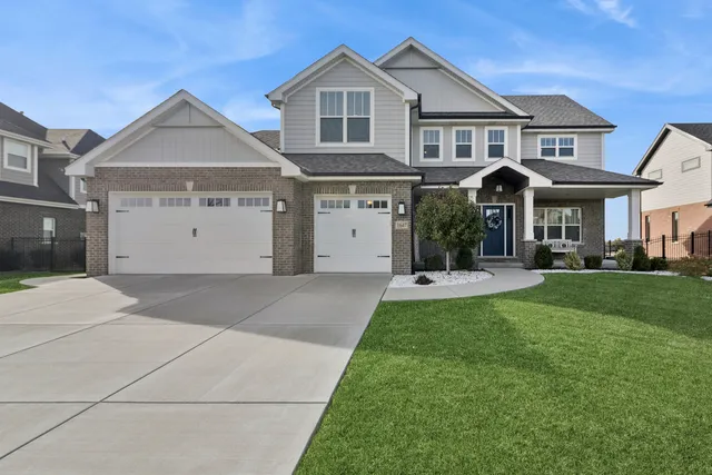 a front view of a house with a yard and garage