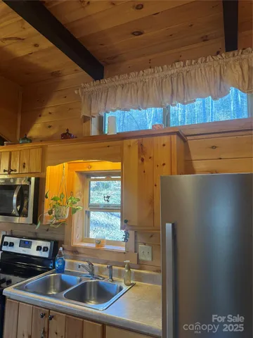 a kitchen with stainless steel appliances a sink a stove and a refrigerator