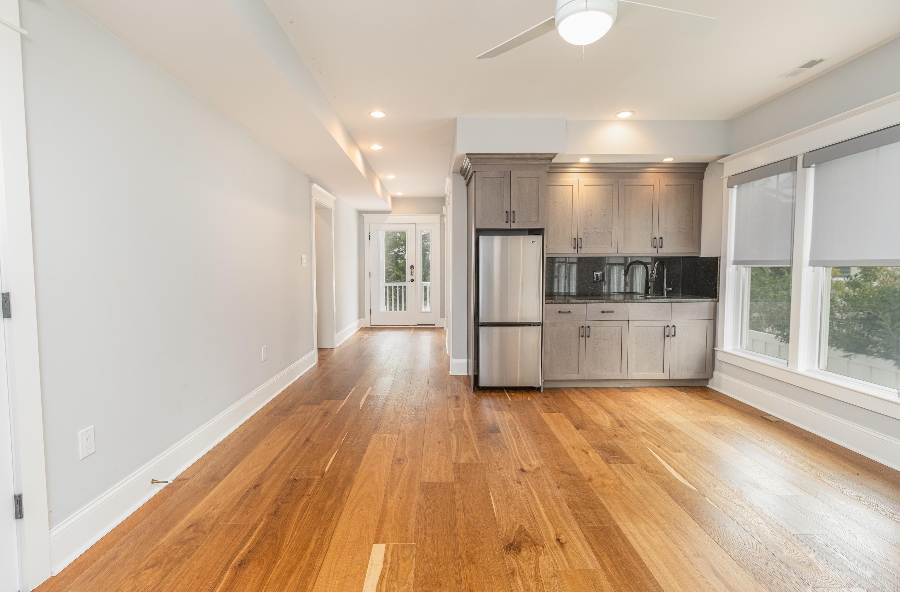 25 West 32nd Avalon, NJ 08202 - Photo 11 of 40 a kitchen with white cabinets and wooden floor