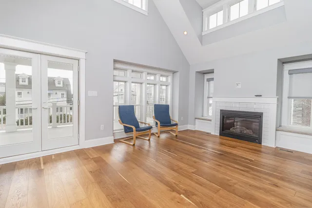 a view of a livingroom with lounge chair and a large window