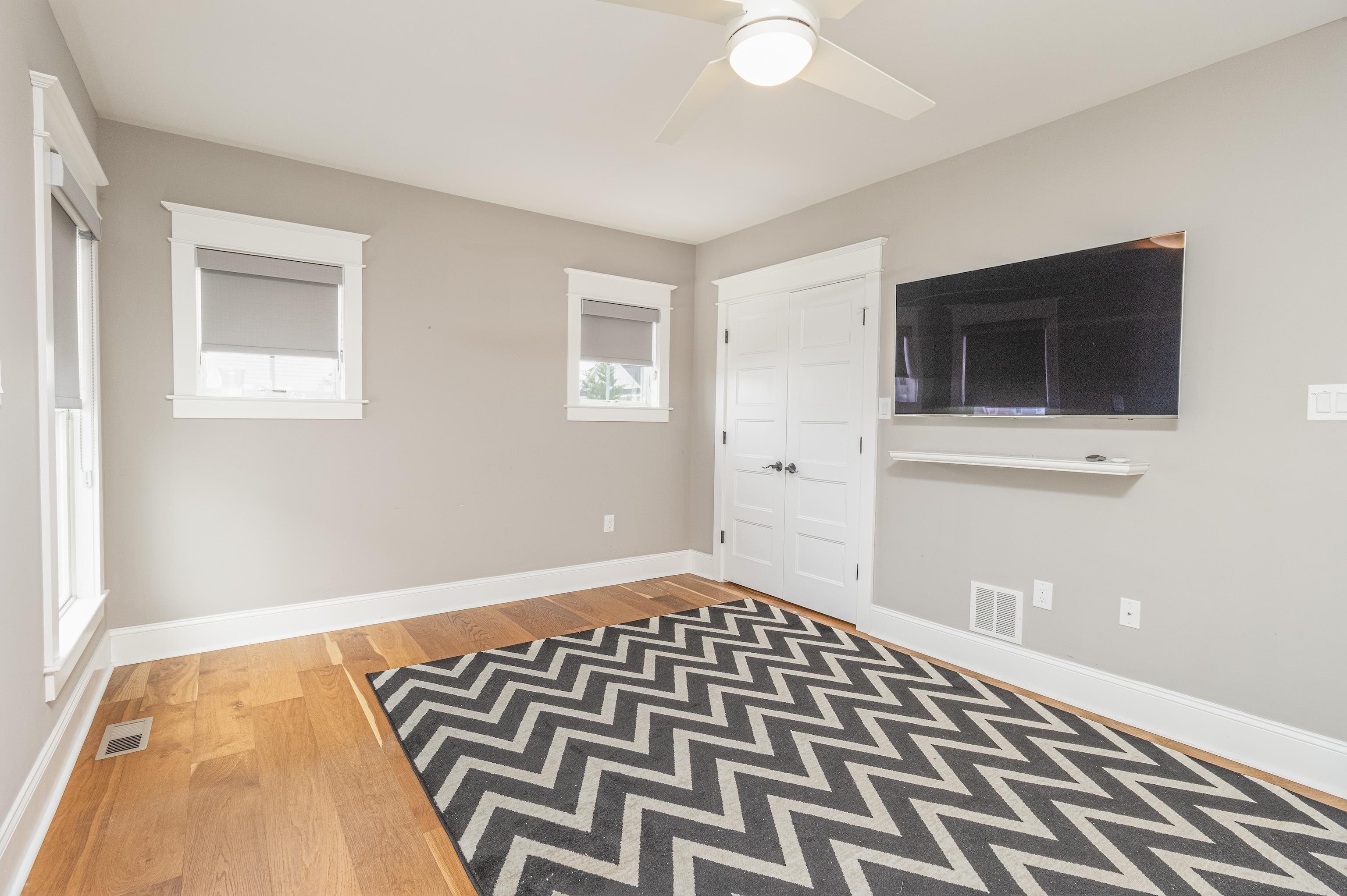 25 West 32nd Avalon, NJ 08202 - Photo 29 of 40 a bedroom with a bed and a flat screen tv