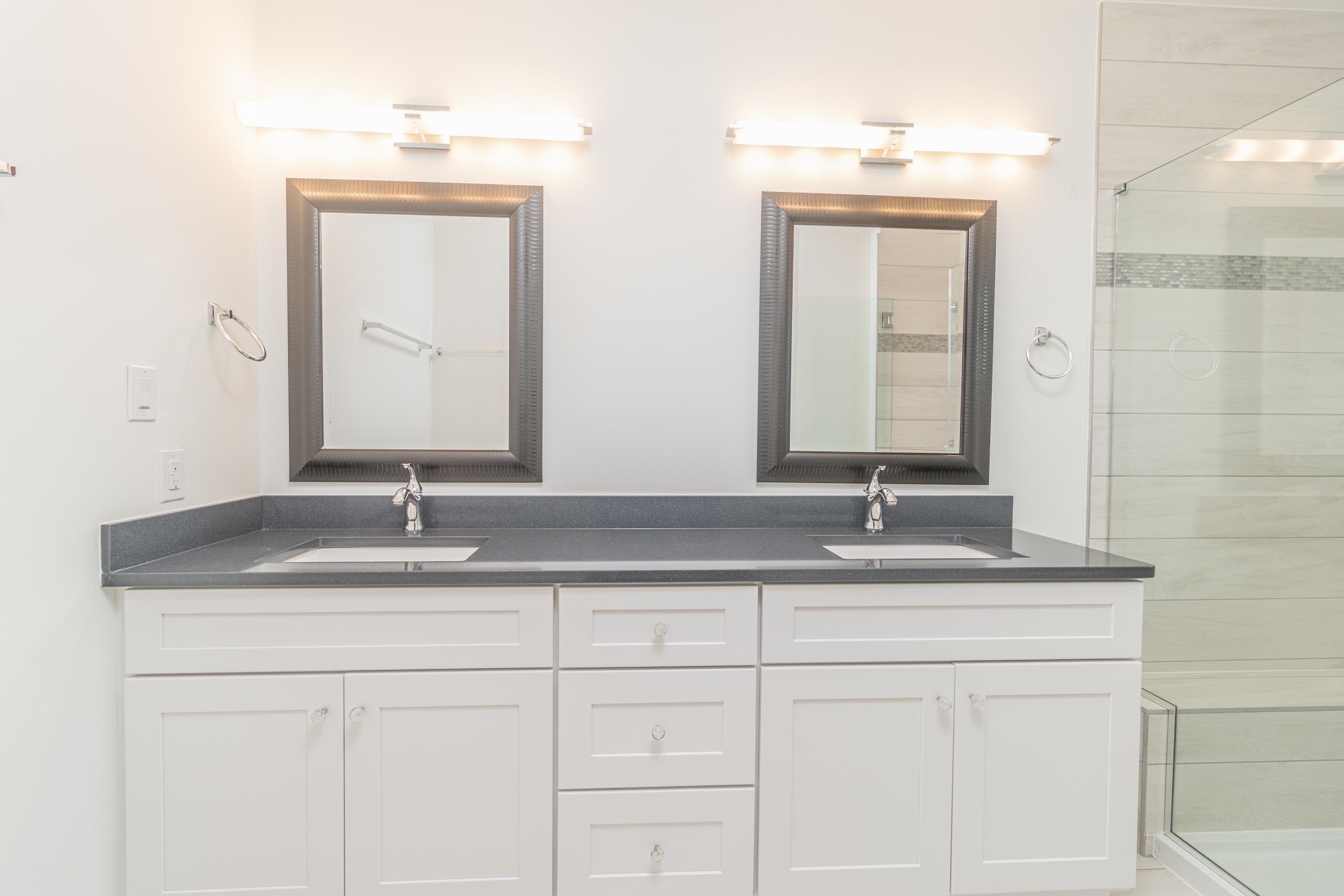 25 West 32nd Avalon, NJ 08202 - Photo 30 of 40 a bathroom with double sink and a mirror