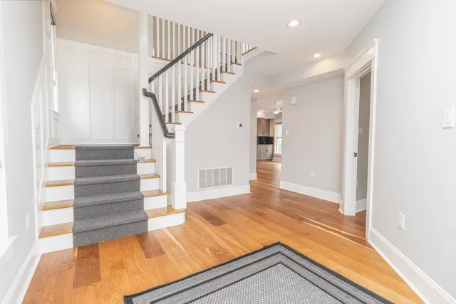 a bed sitting in a spacious bedroom next to a window