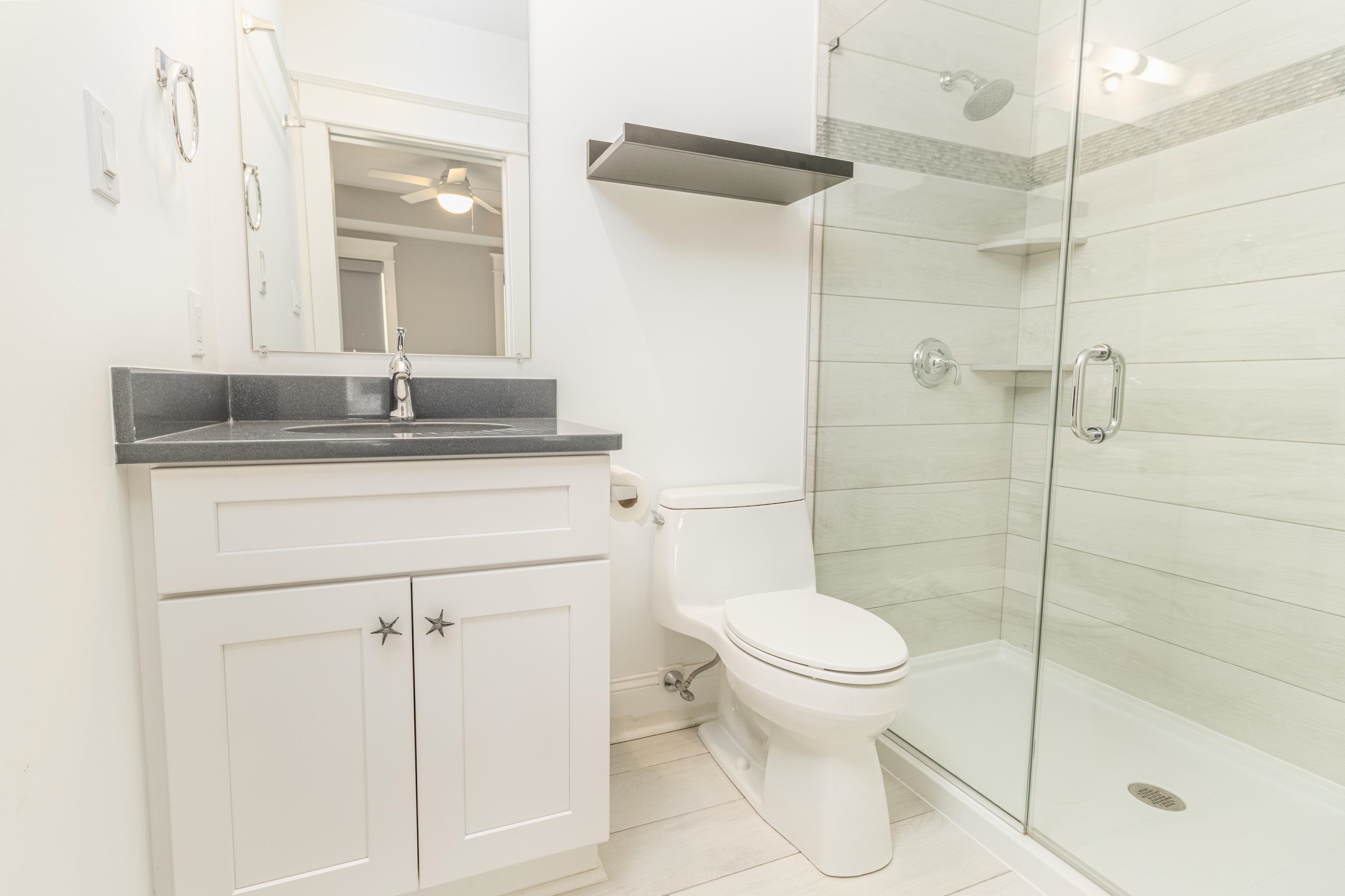 25 West 32nd Avalon, NJ 08202 - Photo 8 of 40 a bathroom with a granite countertop sink toilet and shower
