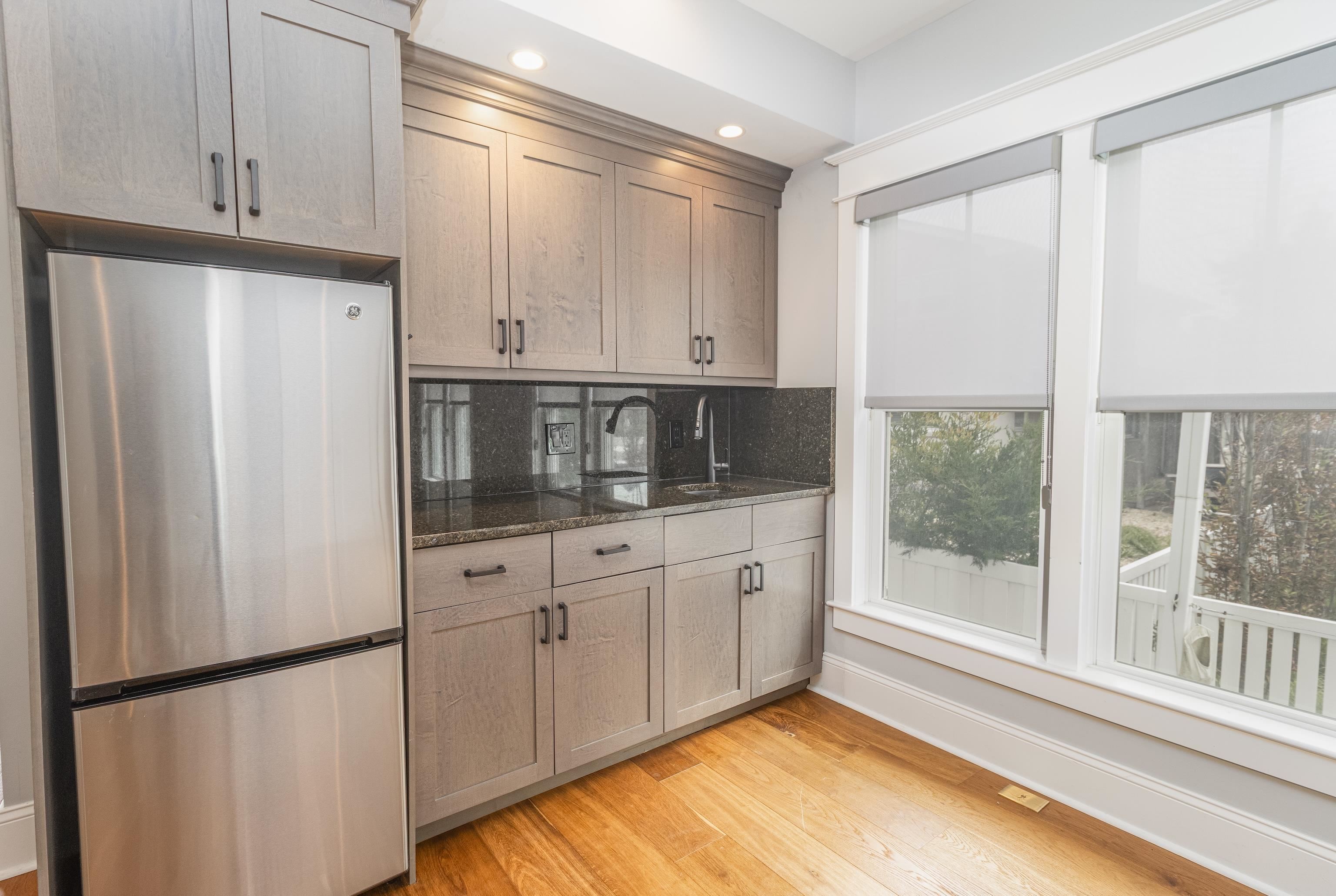 25 West 32nd Avalon, NJ 08202 - Photo 10 of 40 a kitchen with stainless steel appliances granite countertop a refrigerator a sink and white cabinets