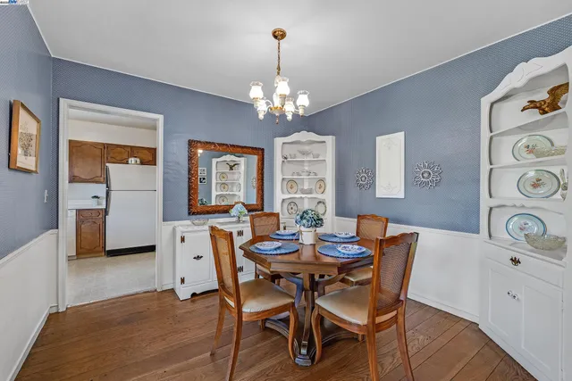 a view of a dining room with furniture and chandelier