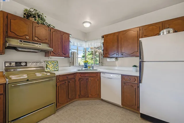 a kitchen with stainless steel appliances granite countertop a refrigerator sink and microwave